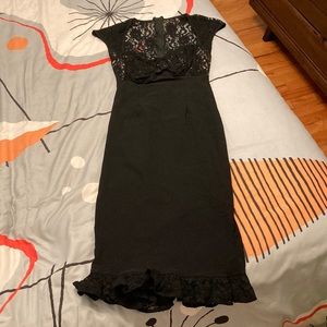 Pinup Couture black wiggle dress with illusion bust and lace ruffle around hem